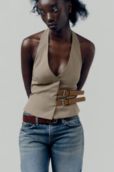 topwear,tops,semi formal, outdoor events,creative workwear, minimal, sophisticated,stretchable,polyester, spandex,beige,solid,contrast,buckle, button, belt,tailored fit,fitted,waist length,v-neck,sleeveless	OY1711,25010066GG
