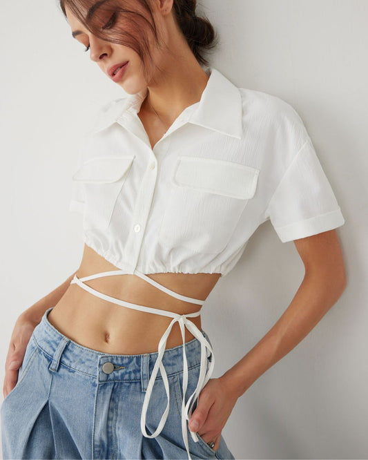 UTILITY POCKET CROP SHIRT,casual, collared, crop, drawstring, drawstring hem, drop shoulder, poplin, regular fit, shirts, short sleeves, solid, streetwear, topwear, utility pocket, white, woven,utility-pocket-crop-shirt-white,Color- White
Fabric- Poplin
Fit- Regular Fit 
Length- Crop
Neck- Collared Neck
Sleeves- Short Sleeves
Hem- Drawstring Hem
Closure- Button Up
No. of Pockets- 2
Print- Solid
Details- Utility pocket and drawstring hem detail