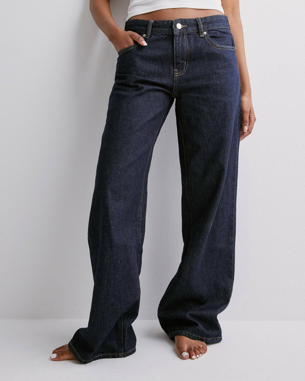 bottomwear,jeans,casual,streetwear,woven,denim,navy blue,relaxed fit,full length,high rise,navy-blue-wide-leg-jeans-navy-blue,Color: Navy Blue
Fabric: Denim
Fit: Wide Leg Fit 
Length: Full Length
Waist: High Rise
Closure: Zip & Button
No. of Pockets: 4
Print: Solid,NAVY BLUE WIDE LEG JEANS