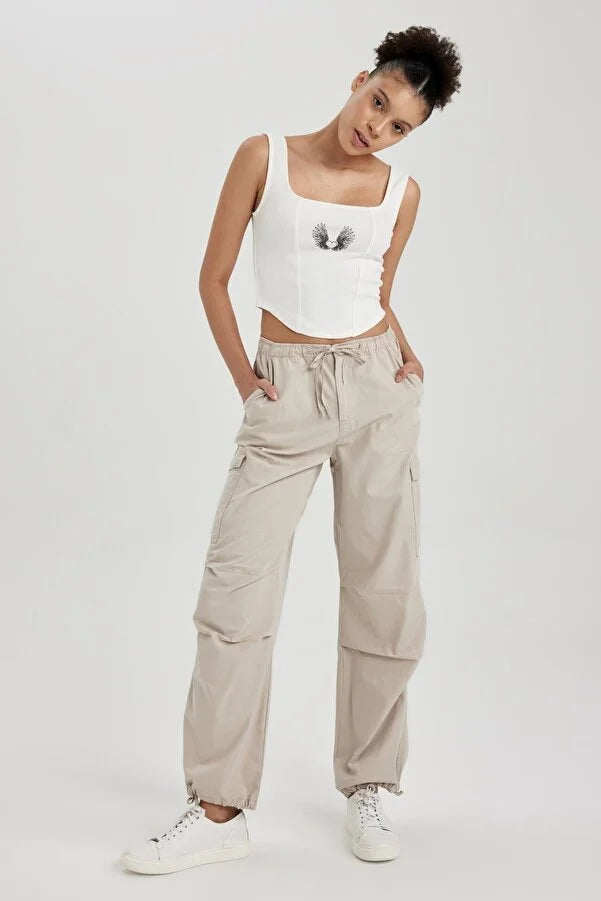 UNISEX CARGO PARACHUTE PANTS,bottomwear, casual, cotton, cream, drawstring, flap pocket, full length, high rise, parachutes, relaxed fit, streetwear, summer, wide leg, woven,unisex-parachute-cargo-trousers-cream,Length- Full length<br data-mce-fragment="1">Waist- High Waist<br data-mce-fragment="1">Fit- Wide Leg<br data-mce-fragment="1">Color- Cream<br data-mce-fragment="1">No. of Pockets- 5<br data-mce-fragment="1">Closure- Zip &amp; Button with Drawstrings<br data-mce-fragment="1">