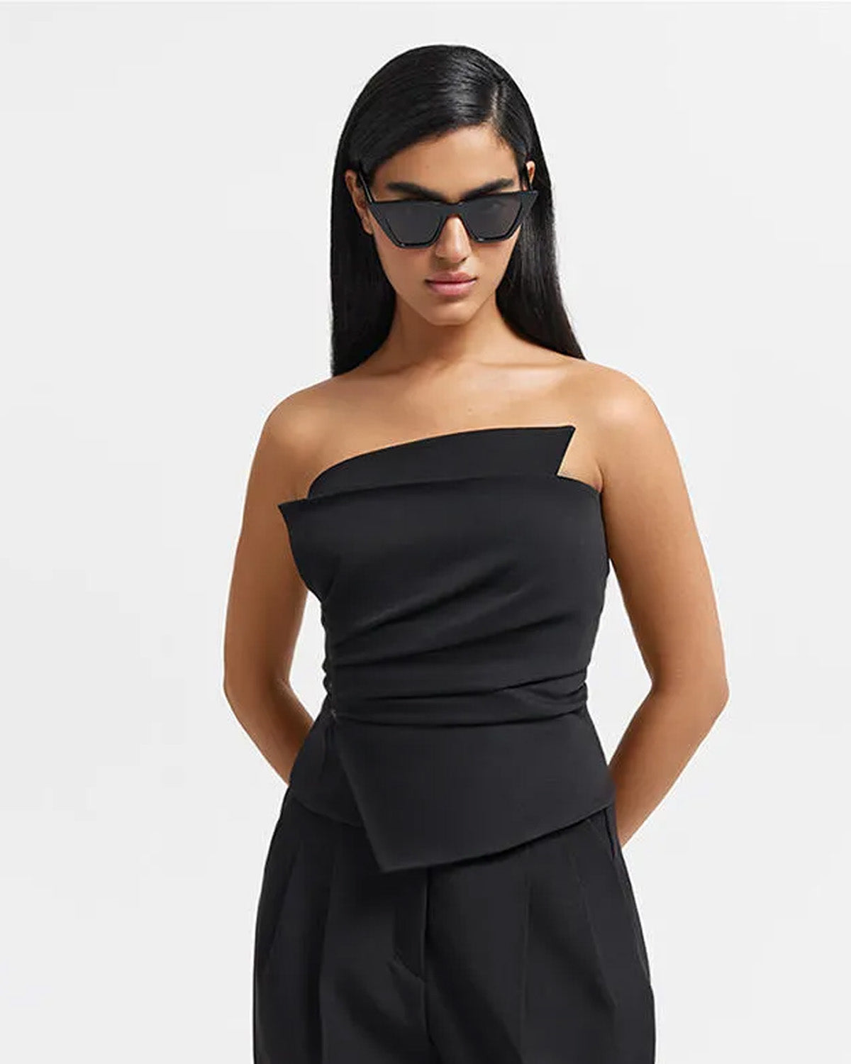topwear,tops,formal, semi-formal, outdoor events,bold, glam, summer,woven,cotton twill,black,solid,pleated,slim fit,bandeau,waist length,asymmetric hem,off shoulder,sleeveless	25010061GG, OY1704