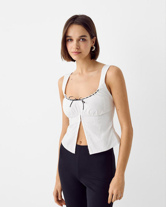 pinktuck-detail-slit-top-white,topwear,tops,casual,streetwear,woven,Stretchable,poplin,white,solid,ruched,regular fit,slit,regular,slit,square neck,shoulder strap,sleeveless,Color: White
Fabric: Poplin
Fit: Skinny Fit 
Length: Regular
Neck: Square Neck
Closure: Hook & Eye
Print: Solid
Details: Pintuck seam detailing adds texture and structure. The contrast bow tie at the center adds a feminine touch.,PINKTUCK DETAIL SLIT TOP