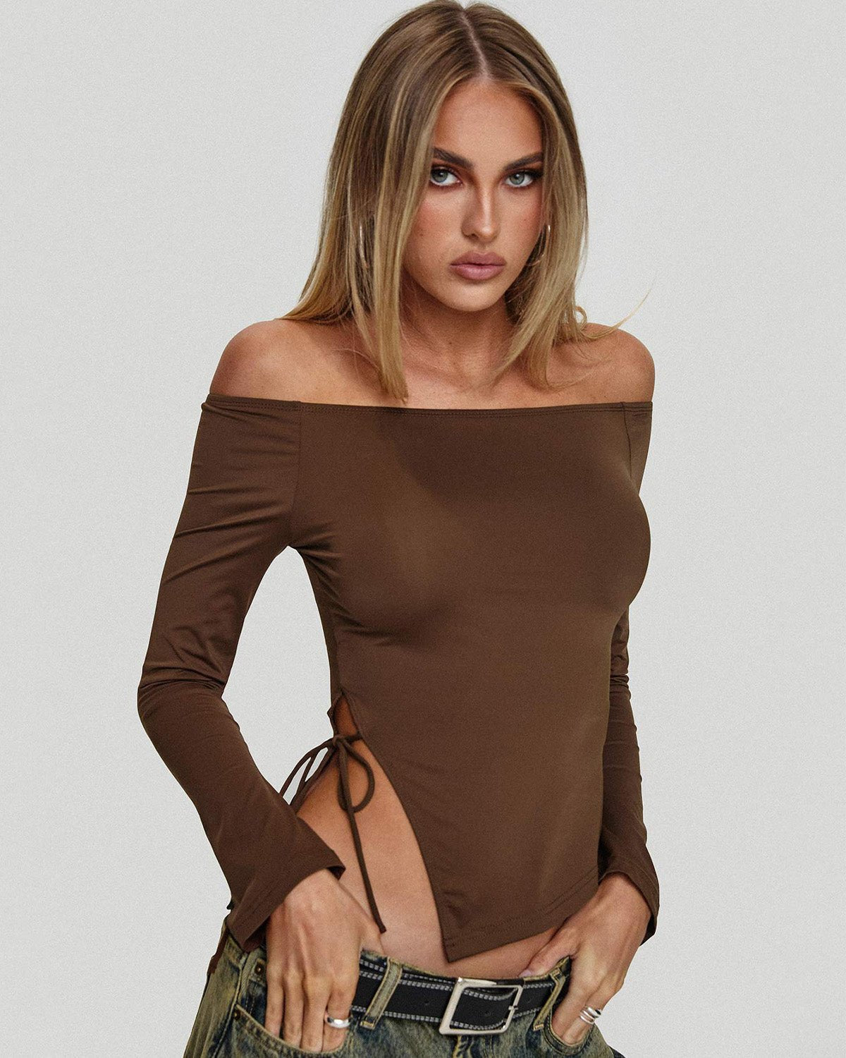 side-slit-off-shoulder-brown-top-brown-oy1508,25010008GG52,topwear,tops,vacation, outdoor events,bold, glam, streetwear,knitted,ribbed,brown,solid,slit,slim fit,fitted,regular,slit hem,off shoulder,long sleeves,Color: Brown
Fabric: Ribbed
Fit: Slim Fit 
Length: Regular
Neck: Off Shoulder
Sleeve: Long Sleeves
Print: Solid
Detail: Side slit with a drawstring tie knot,SIDE SLIT OFF SHOULDER BROWN TOP