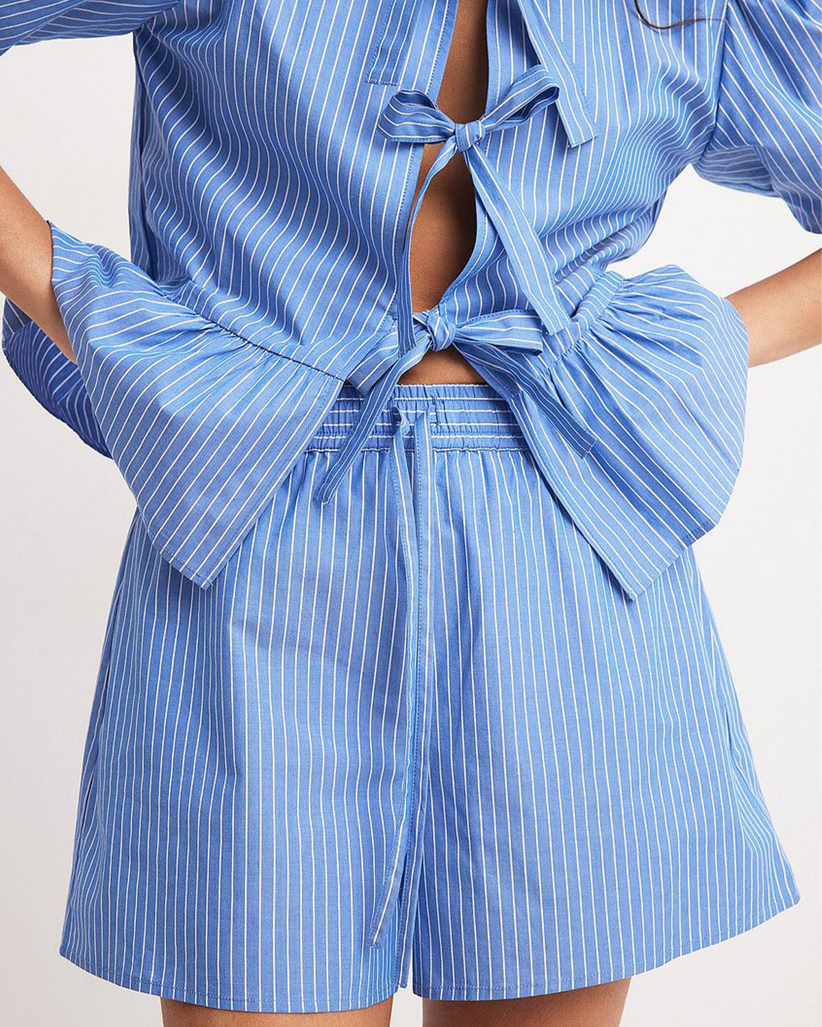 coord sets,bottomwear, topwear,casual, vacation,bold, glam, genz fit, soft girl,woven,polycotton,printed,blue,pinstripes, stripes,gathered, pinstripes, tie knot,drawstring,regular fit top,tie up top,waist length top,flared hem,round neck,puff sleeves,elbow length sleeves,shorts,mini shorts,mini,straight hem,mid rise waist,25060047GG, OY2015