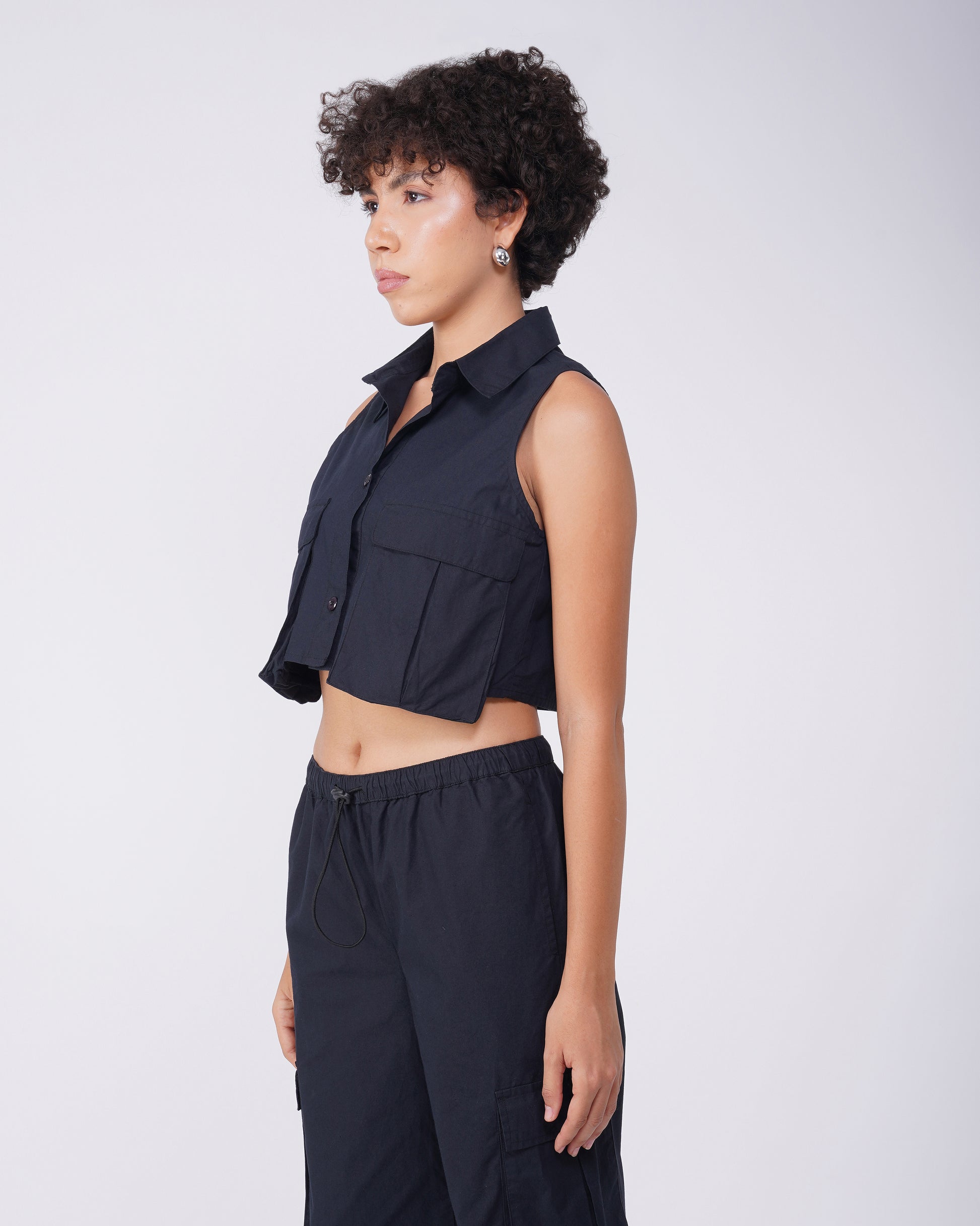 flap-pocket-co-ord-crop-shirt-black,FLAP POCKET CO-ORD CROP SHIRT,Color: BlackFabric: Cotton, PoplinFit: Regular Fit Length: CropNeck: CollaredSleeves: SleevelessClosure: Button-UpPrint: SolidDetails: Flap-Pocket,coord sets,tops,casual,streetwear,woven,cotton, poplin,black,solid,flap pocket, utility pocket,regular fit,crop,crop,collared,sleeveless,Manufacturing batch1_June19