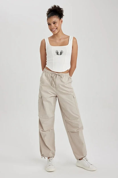 UNISEX CARGO PARACHUTE PANTS,bottomwear, casual, cotton, cream, drawstring, flap pocket, full length, high rise, parachutes, relaxed fit, streetwear, summer, wide leg, woven,unisex-parachute-cargo-trousers-cream,Length- Full length<br data-mce-fragment="1">Waist- High Waist<br data-mce-fragment="1">Fit- Wide Leg<br data-mce-fragment="1">Color- Cream<br data-mce-fragment="1">No. of Pockets- 5<br data-mce-fragment="1">Closure- Zip &amp; Button with Drawstrings<br data-mce-fragment="1">