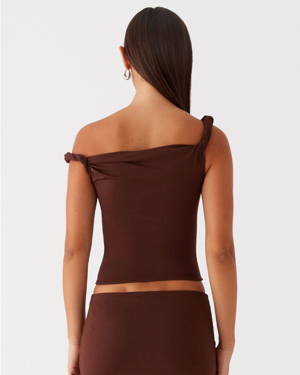 twisted-shoulder-strap-fitted-top-brown-oy1501,25010001GG52,topwear,tops,party, vacation,bold, glam, streetwear,knitted, stretchable,ribbed,brown,solid,twisted,skinny fit,fitted,regular,one shoulder,shoulder strap,sleeveless,Color: Brown coord sets,skirts,vacation,beach, glam, summer, streetwear,knitted,ribbed,brown,twisted,skinny fit,pencil skirt,full len
Fabric: Ribbed
Fit: Skinny Fit 
Length: Regular
Neck: One Shoulder
Print: Solid 
Details: Twisted shoulder strap ,TWISTED SHOULDER STRAP FITTED TOP