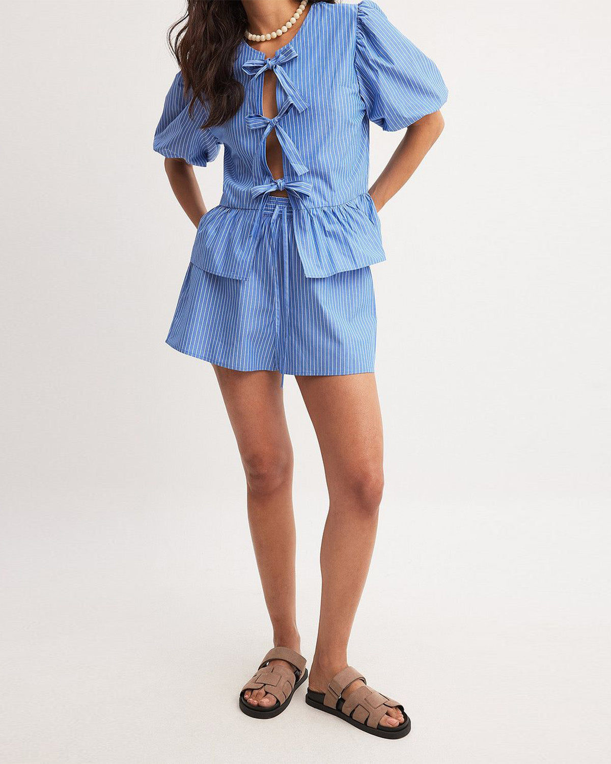 coord sets,bottomwear, topwear,casual, vacation,bold, glam, genz fit, soft girl,woven,polycotton,printed,blue,pinstripes, stripes,gathered, pinstripes, tie knot,drawstring,regular fit top,tie up top,waist length top,flared hem,round neck,puff sleeves,elbow length sleeves,shorts,mini shorts,mini,straight hem,mid rise waist,25060047GG, OY2015