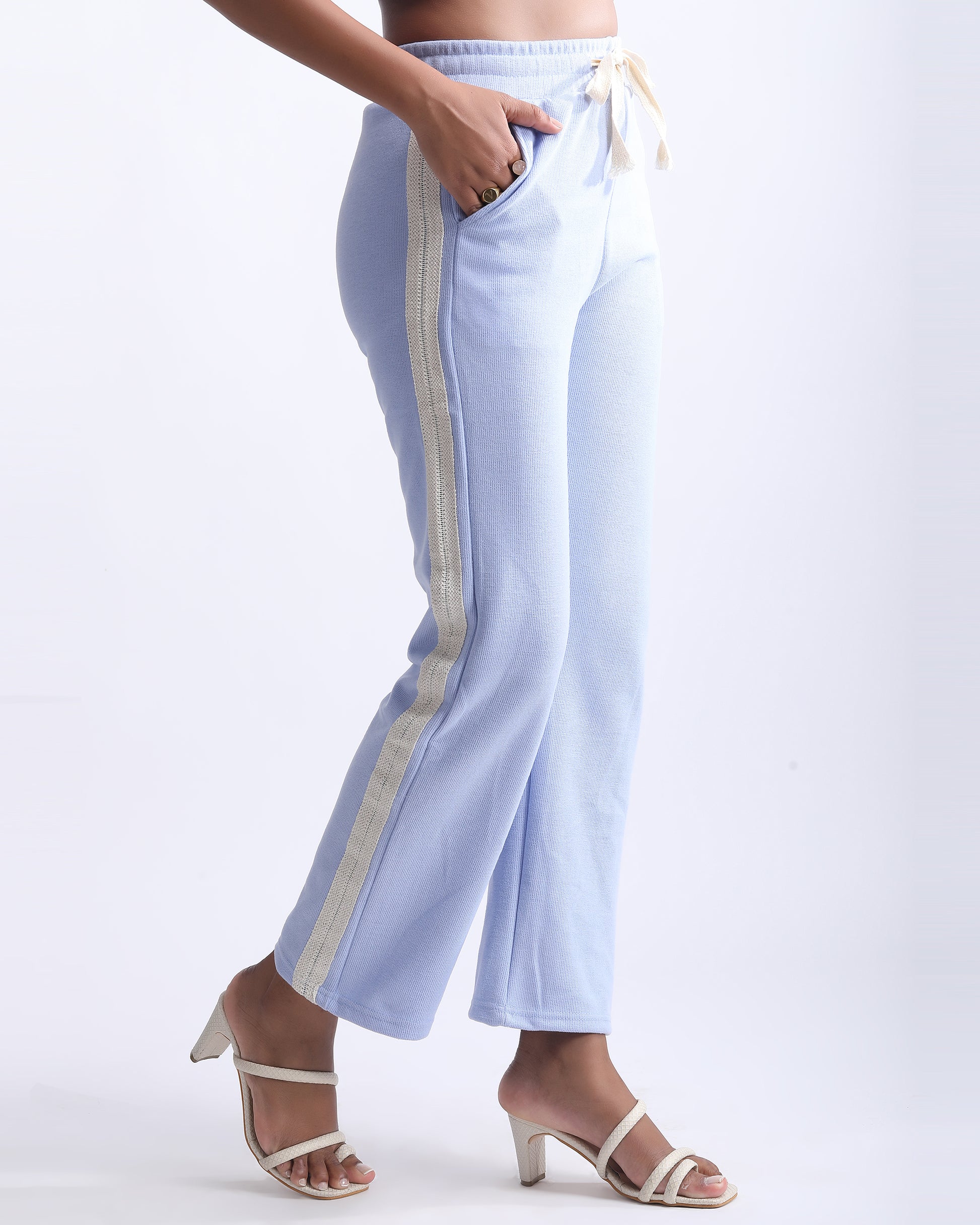 HIGH RISE LOUNGE TROUSER,blue, bottomwear, full length, high rise, knitted, lace, loungewear, relaxed fit, ribbed, trousers, wide leg,high-rise-lounge-trouser-blue,Color- Blue  
Fit- Straight Fit 
Length- Full 
Waist- High Rise 
Closure- Elasticated 
No. of Pockets- 2 
Fabric- Ribbed  
Print/ Pattern- Solid 
Details/Design Elements- Laced