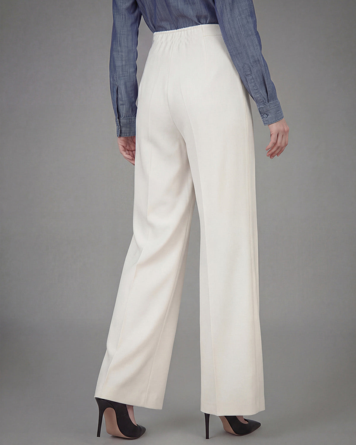 SCULPTED WAIST PLEATED TROUSERS,Color: White
Fabric: 95% poly 5% spandex
Fit: Tailored Fit
Length: Full Length(41")
Waist: High Rise 
Closure: Elasticated
No. of Pockets: 2
Print: Solid
Details: Corset shaped panel in front for a clinched waist look,pants,bottomwear,pants,semi-formal,business outfit,stretchable,polyester, spandex,white,pleated,tailored fit,wide leg,full length,high rise