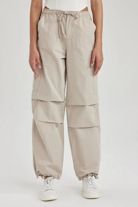 UNISEX CARGO PARACHUTE PANTS,bottomwear, casual, cotton, cream, drawstring, flap pocket, full length, high rise, parachutes, relaxed fit, streetwear, summer, wide leg, woven,unisex-parachute-cargo-trousers-cream,Length- Full length<br data-mce-fragment="1">Waist- High Waist<br data-mce-fragment="1">Fit- Wide Leg<br data-mce-fragment="1">Color- Cream<br data-mce-fragment="1">No. of Pockets- 5<br data-mce-fragment="1">Closure- Zip &amp; Button with Drawstrings<br data-mce-fragment="1">