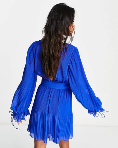 pleated-mini-dress-blue,PLEATED MINI DRESS,Color: Blue
Fabric: Georgette
Type: A-Line
Fit: Regular Fit
Length: Mini
Neck: Plunge Neckline
Sleeve: Bishop Sleeve
Closure: Button
Trims: Belt
Print: Solid
Details: Pleated Fabric,dresses,dresses,vacation,glam,woven,georgette,blue,solid,pleated,belt,regular fit,a line,mini,plunge neckline,bishop sleeves,long sleeves,deep back