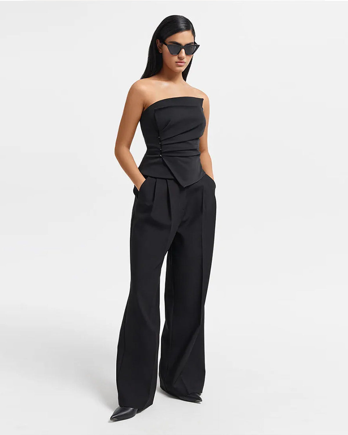topwear,tops,formal, semi-formal, outdoor events,bold, glam, summer,woven,cotton twill,black,solid,pleated,slim fit,bandeau,waist length,asymmetric hem,off shoulder,sleeveless	25010061GG, OY1704