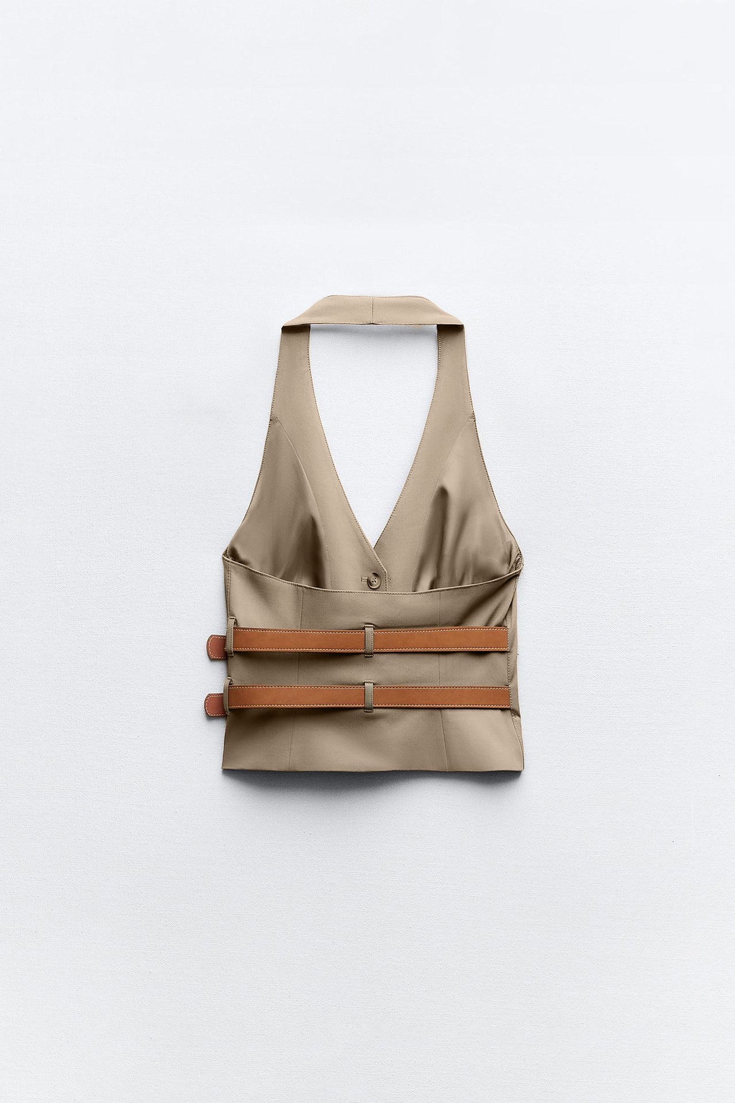 topwear,tops,semi formal, outdoor events,creative workwear, minimal, sophisticated,stretchable,polyester, spandex,beige,solid,contrast,buckle, button, belt,tailored fit,fitted,waist length,v-neck,sleeveless	OY1711,25010066GG