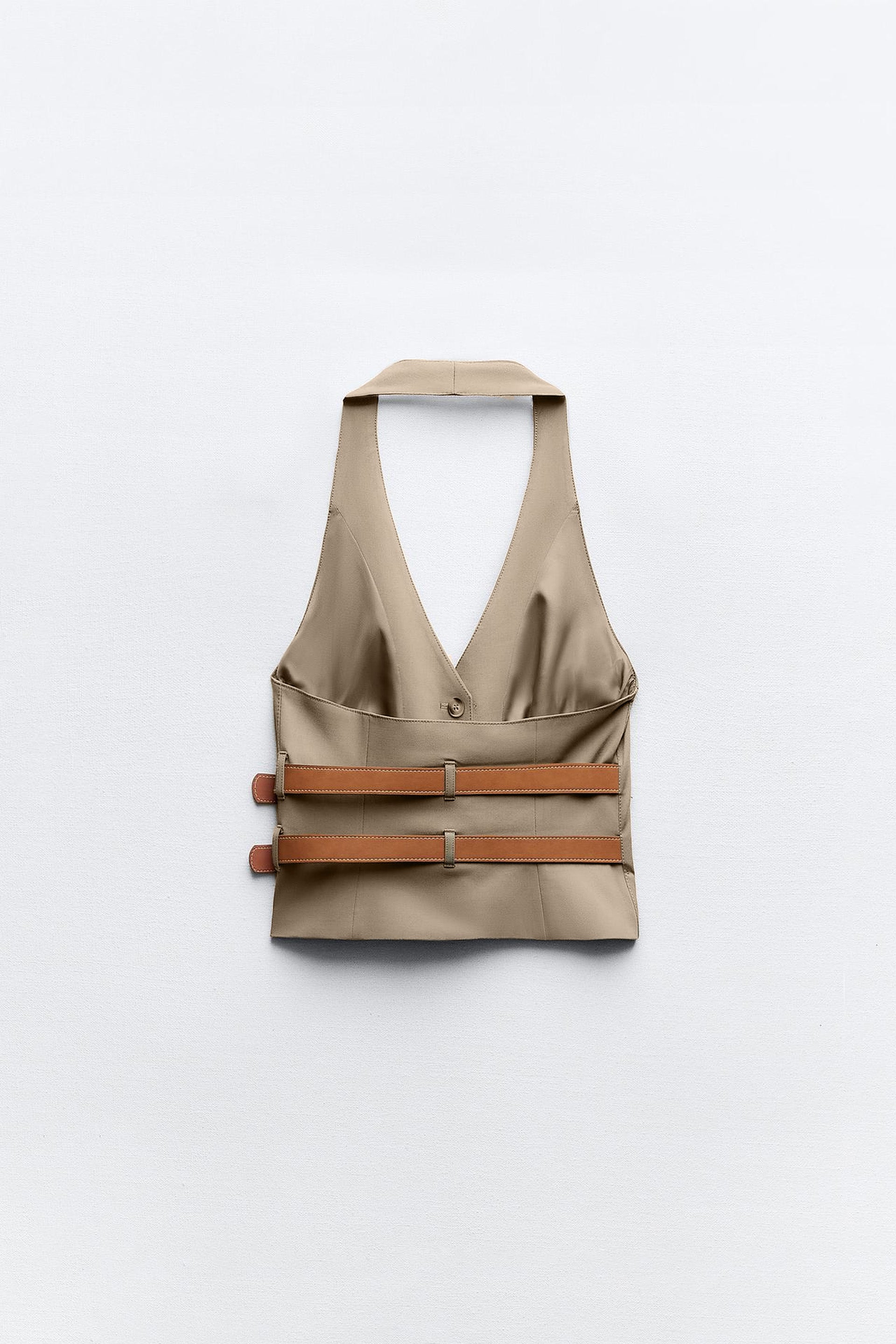 topwear,tops,semi formal, outdoor events,creative workwear, minimal, sophisticated,stretchable,polyester, spandex,beige,solid,contrast,buckle, button, belt,tailored fit,fitted,waist length,v-neck,sleeveless	OY1711,25010066GG