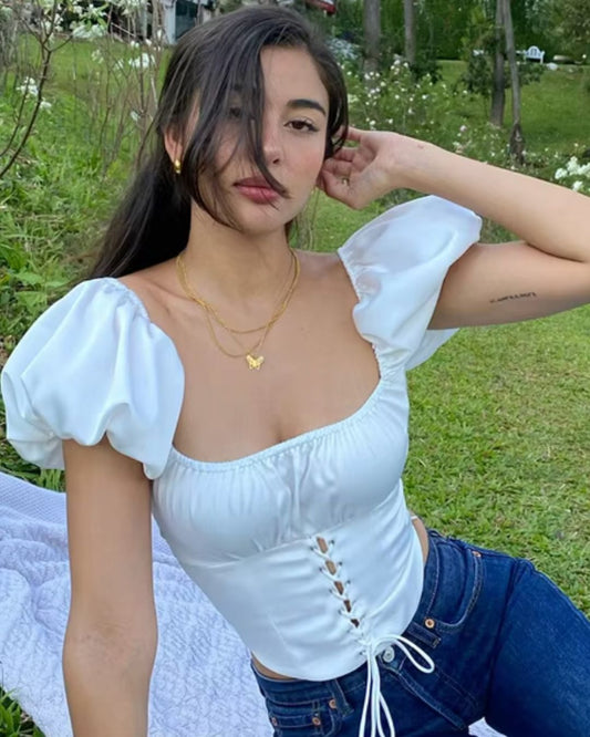 topwear,tops,casual, vacation, outdoor events,minimal, soft girl, summer,woven,satin,white,solid,criss cross detail, ruched,drawstring,slim fit,fitted,waist length,curved hem,square neck,puff sleeves,short sleeves	25050014GG, OY1022