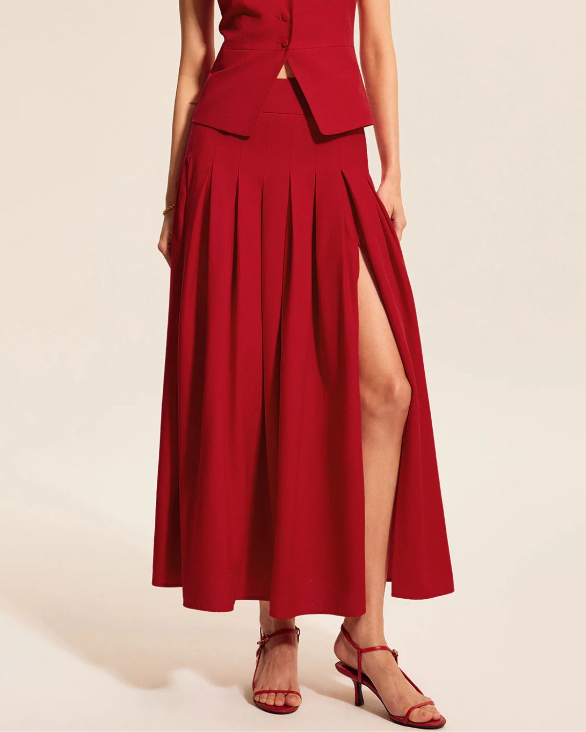 coord sets,bottomwear, topwear,casual, casual chic, outdoor events,bold, genz fit, sophisticated, summer, urban fit,woven,cotton twill,red,solid,panelling, pleated,button, zipper,tailored fit top,vest,waist length top,slit hem,square neck,shoulder strap,no sleeves,sleeveless,button down top,skirts,pleated skirt,midi skirt,slit hem,mid rise waist,no pockets
OY3047,	25070019GG