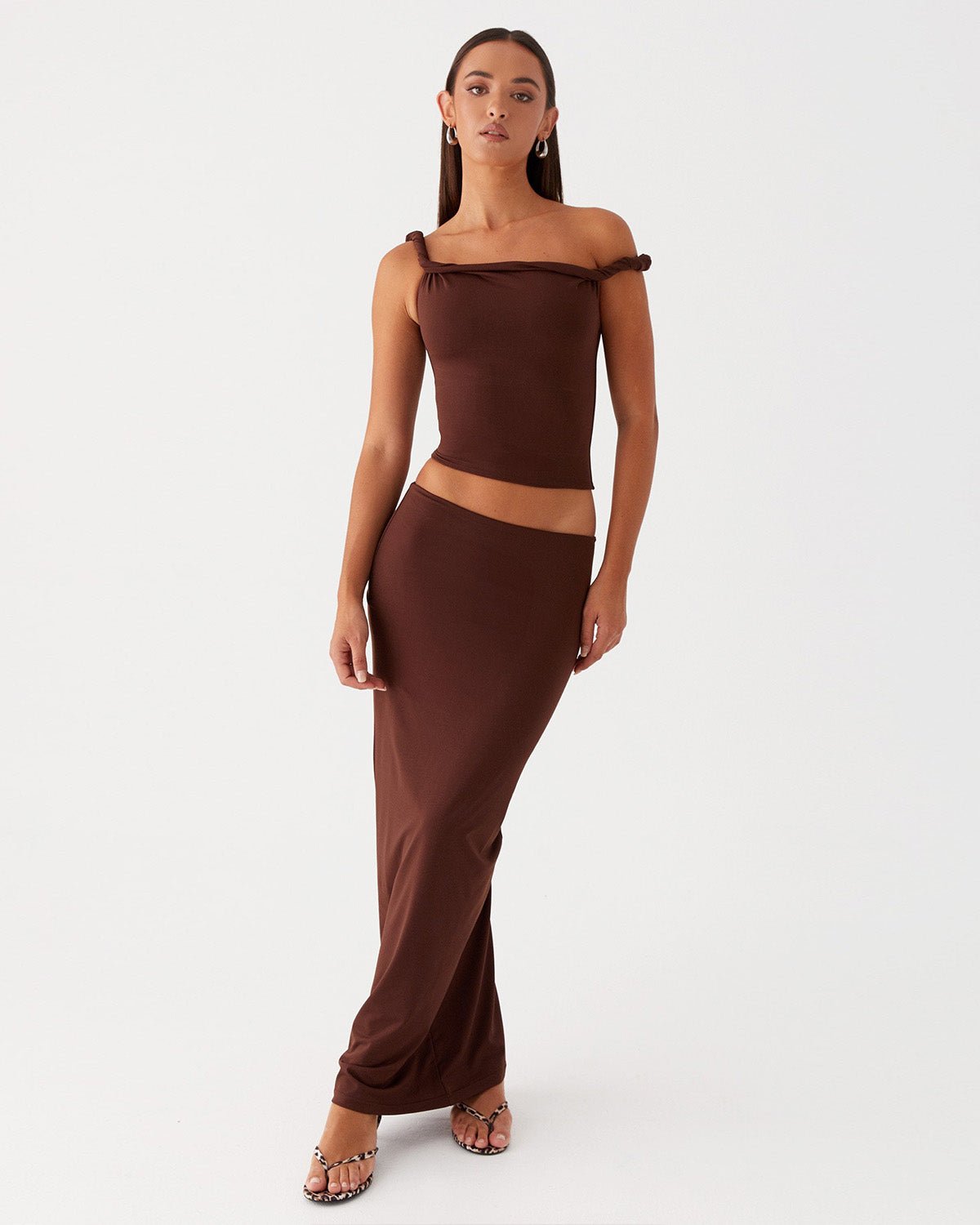 twisted-shoulder-strap-fitted-top-brown-oy1501,25010001GG52,topwear,tops,party, vacation,bold, glam, streetwear,knitted, stretchable,ribbed,brown,solid,twisted,skinny fit,fitted,regular,one shoulder,shoulder strap,sleeveless,Color: Brown coord sets,skirts,vacation,beach, glam, summer, streetwear,knitted,ribbed,brown,twisted,skinny fit,pencil skirt,full len
Fabric: Ribbed
Fit: Skinny Fit 
Length: Regular
Neck: One Shoulder
Print: Solid 
Details: Twisted shoulder strap ,TWISTED SHOULDER STRAP FITTED TOP